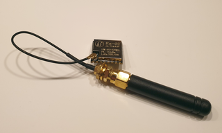 Image of 915 Mhz Quarter-Wave Antenna Attached to Tiny Radio Module